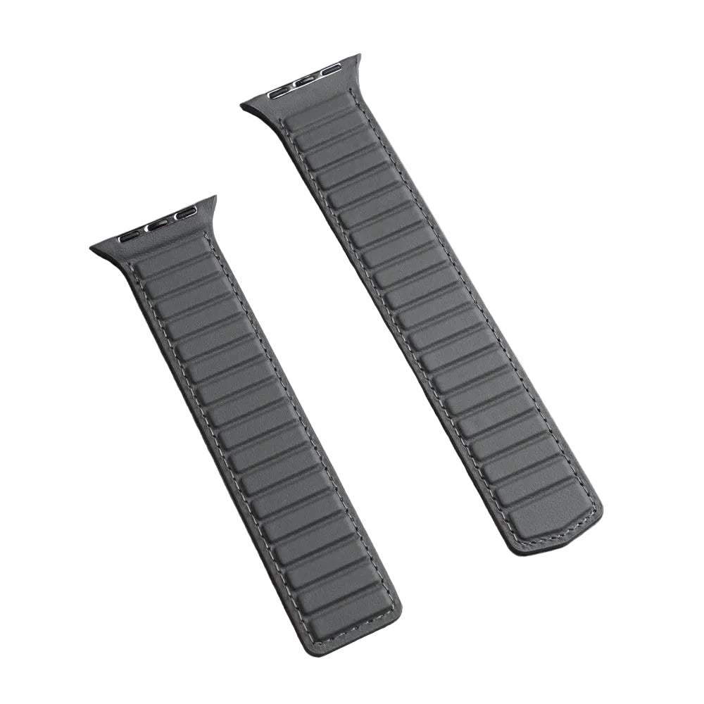 Two dark gray leather watch straps with stitched edges, laid diagonally on a textured light gray surface.