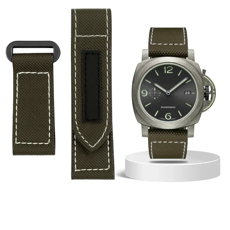 Watch with green strap and black dial on a white background, with additional strap and tools displayed.