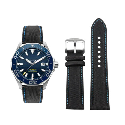 Watch with blue face and black strap, accompanied by a separate black strap on a white background