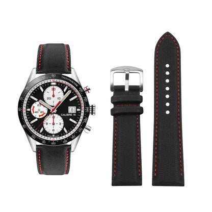 Black watch with red stitching and additional black strap on a white background